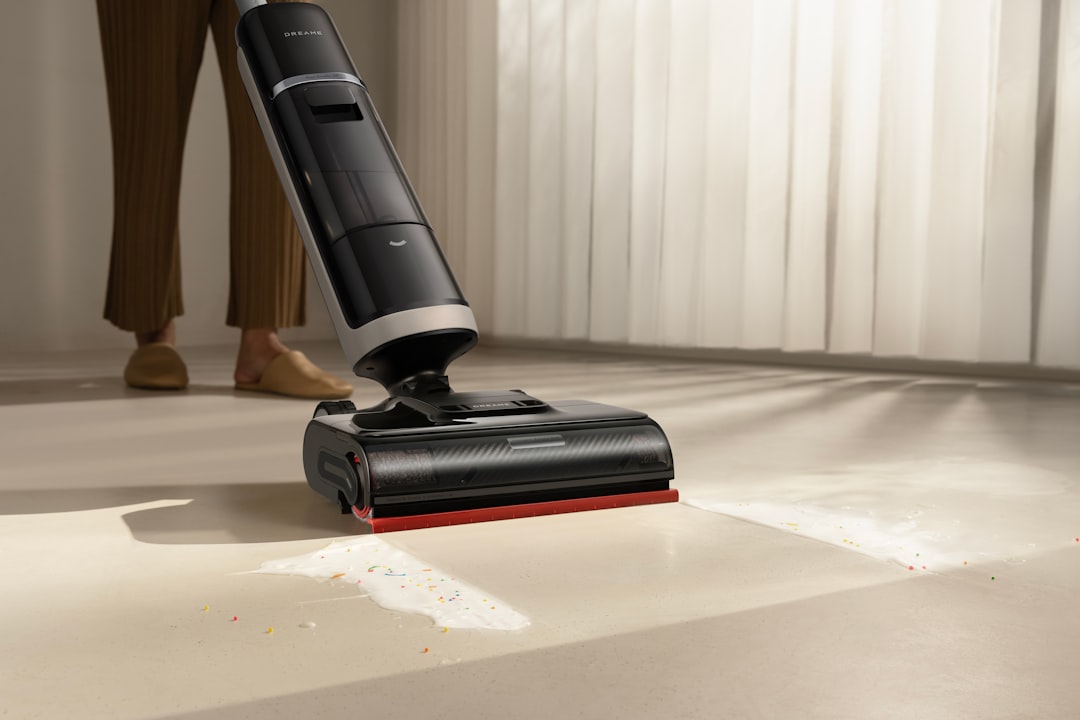 A close-up shows a Dreame wet dry vacuum lifting a liquid spill from the floor, emphasizing powerful floor cleaner results.